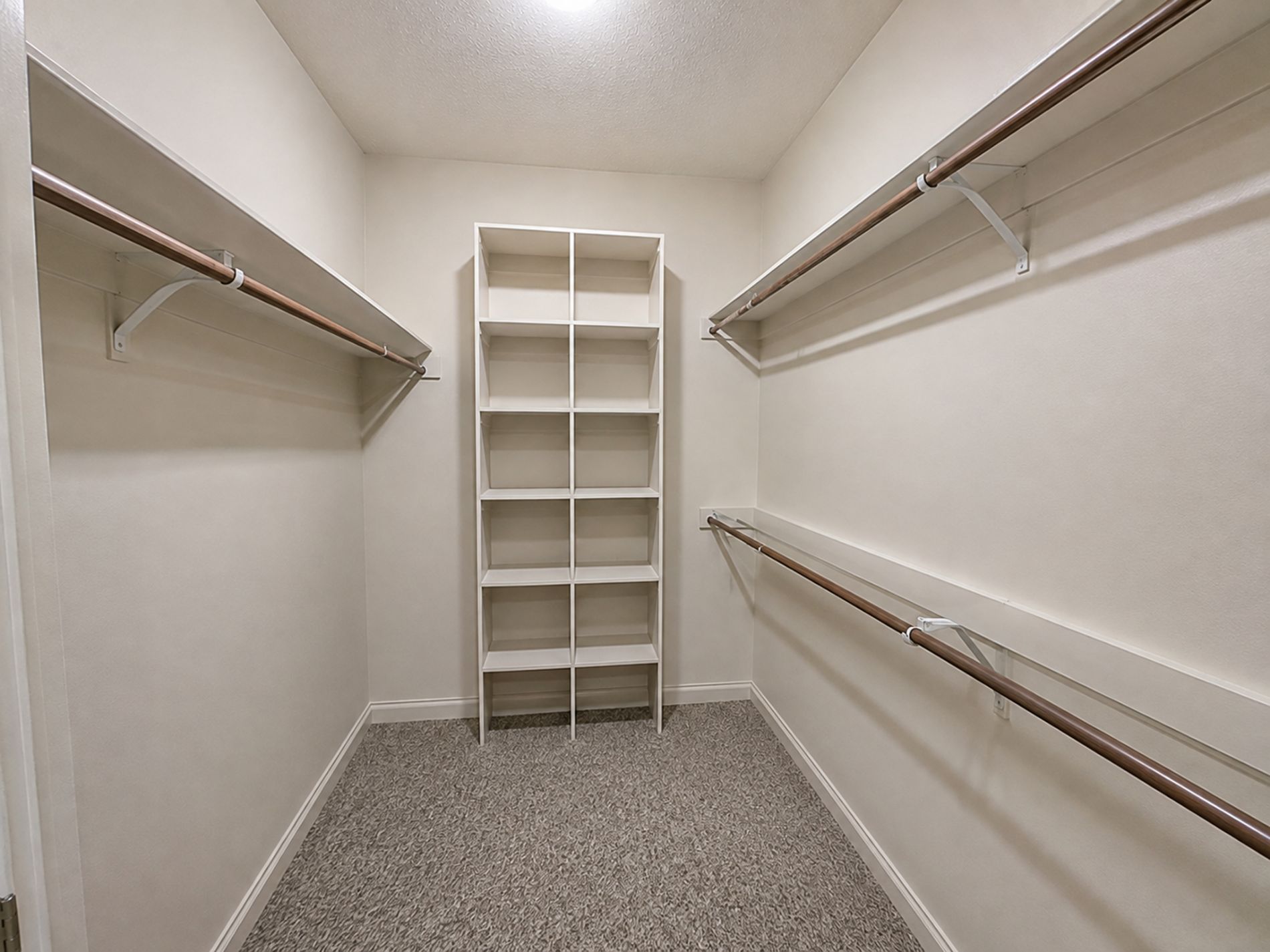 Primary bedroom walk-in closet Primary bedroom walk-in closet