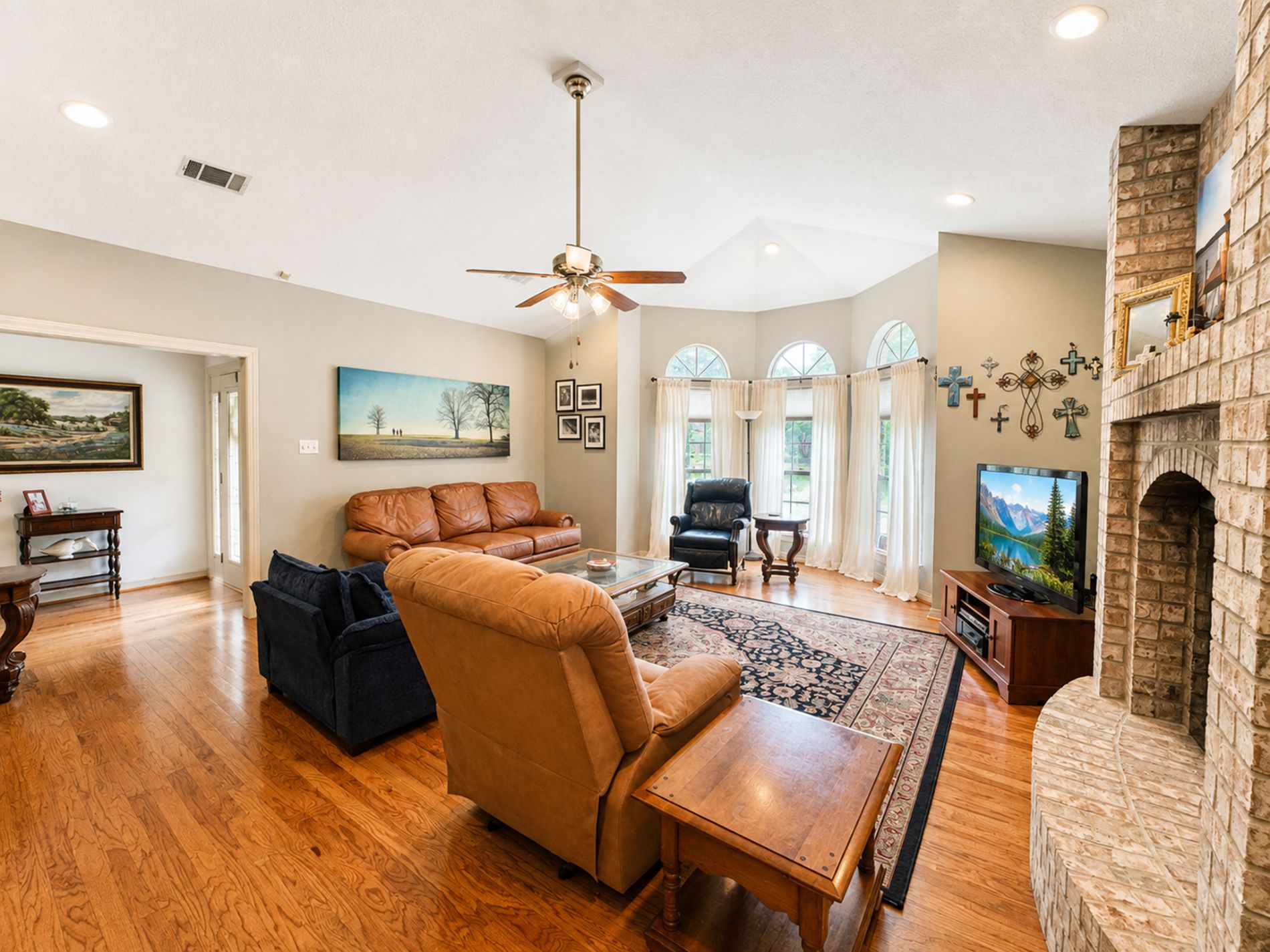 Living room filled with natural light from bay windows, anchored by a beautiful fireplace. Living room filled with natural light from bay windows, anchored by a beautiful fireplace.