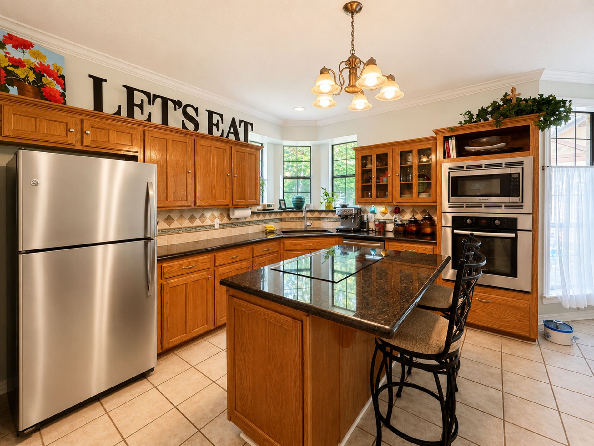 The Kitchen features stainless steel Bosch appliances (oven, microwave, dishwasher), GE Profile induction cooktop, and granite countertops The Kitchen features stainless steel Bosch appliances (oven, microwave, dishwasher), GE Profile induction cooktop, and granite countertops